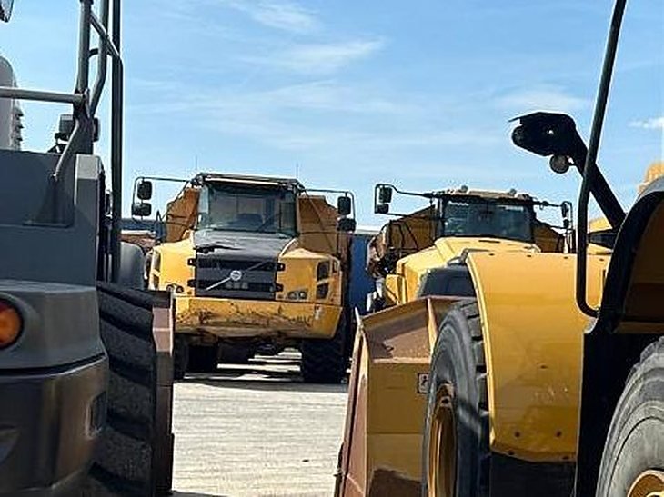 Volvo articulated dump trucks parked in a European equipment yard