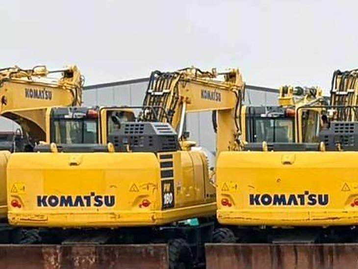 Row of Komatsu tracked excavators in a European equipment yard