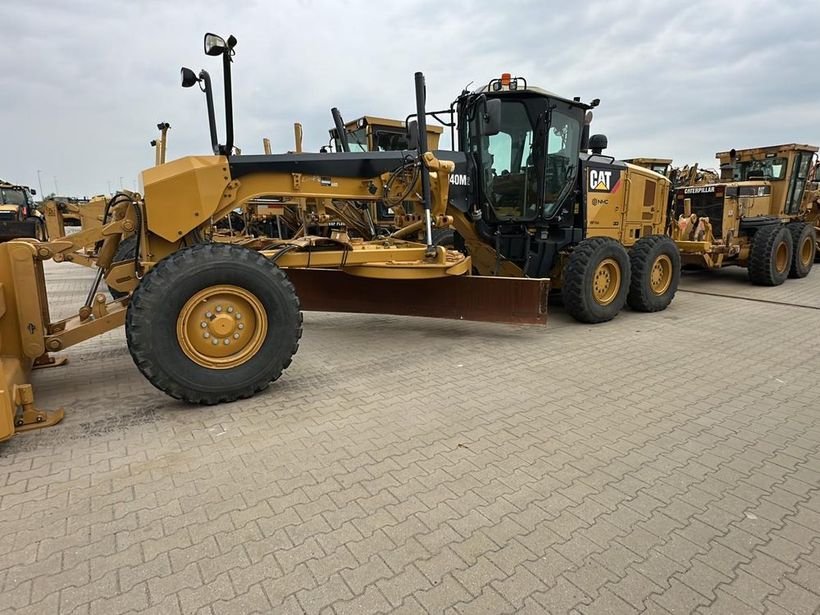Caterpillar 140M2 motor grader in a European equipment yard