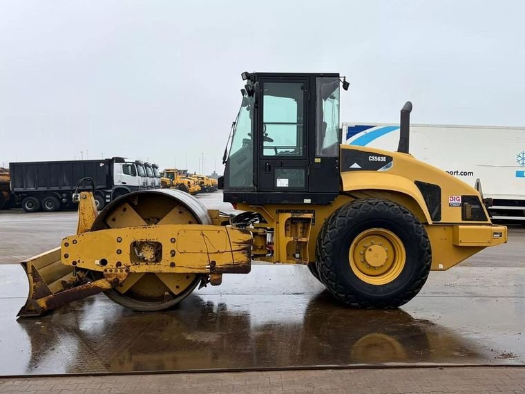 Caterpillar CS563E single-drum soil compactor with dozer blade